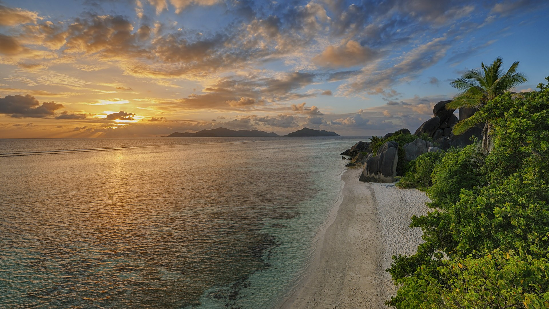 1920x1080 View to Anse Source d' Argent with sculpted rocks and palm trees at sunset, La Digue, Seychelles | Windows 10 Spotlight Images