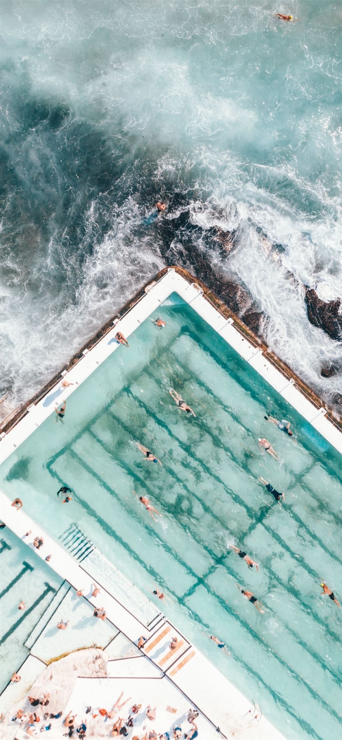 1170x2532 pool with people swimming nearby seashore iPhone 12 Wallpapers Free Download