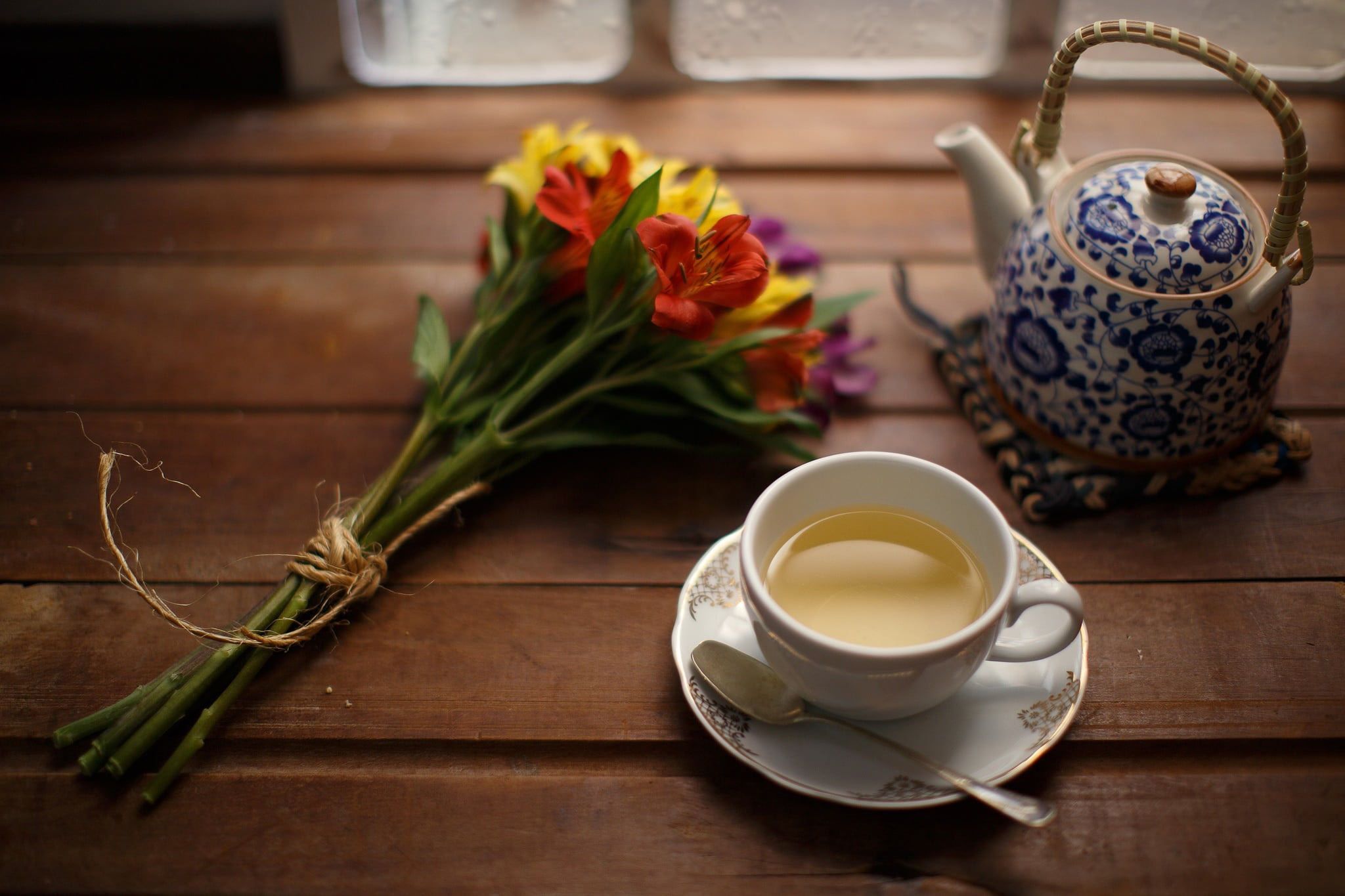 2048x1365 Photography of white ceramic teacup set; blue and white ceramic teapot; and red and yellow petaled flowers, tea, flowers HD wallpaper