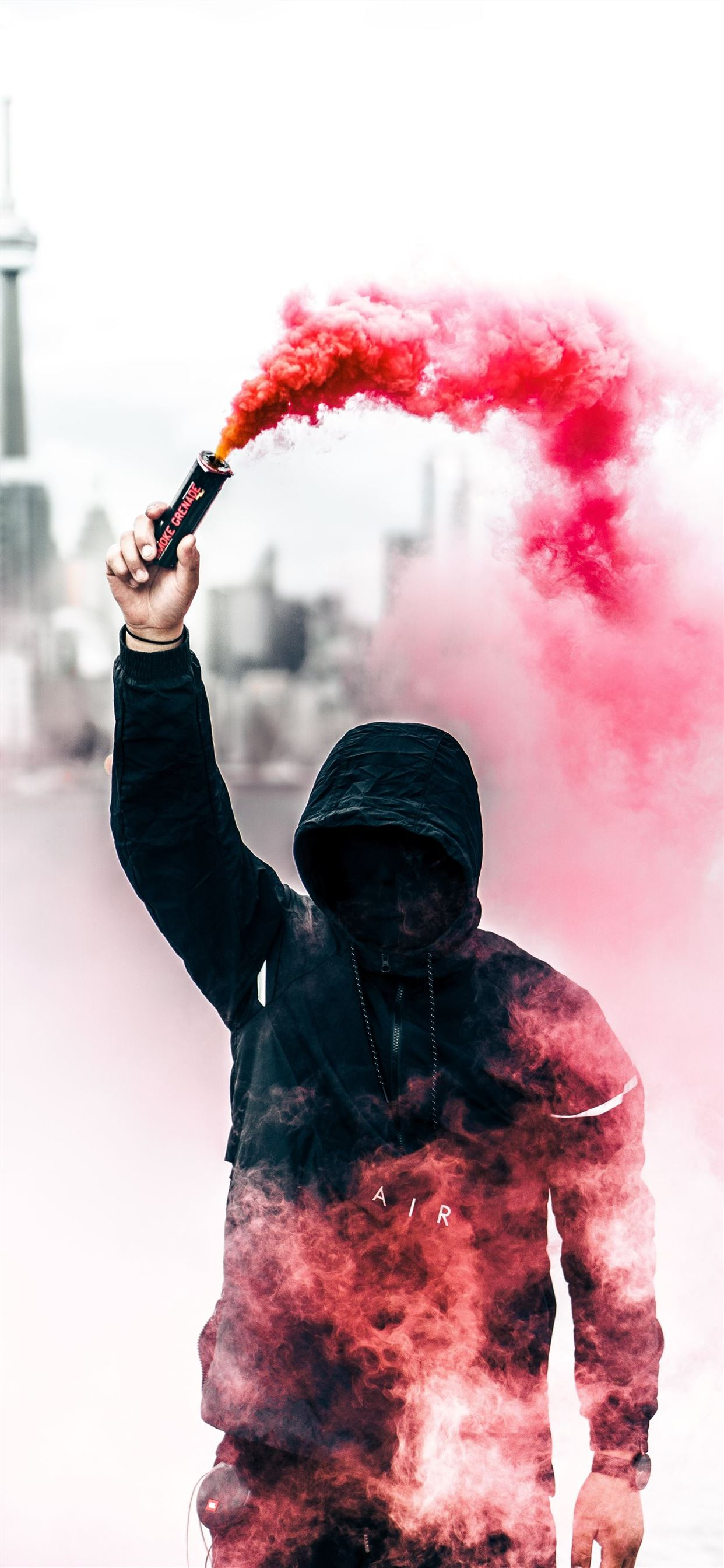 1242x2688 person wearing black and red hoodie holding smoke ... iPhone 11 Wallpapers Free Download